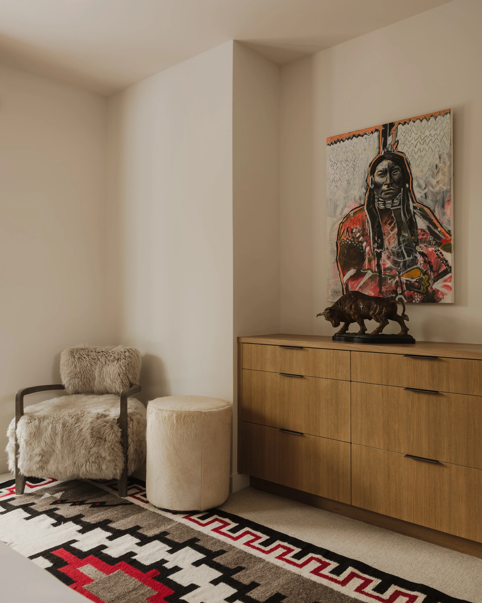 Styled entry nook with shearling chair and Native American artwork — interior design photography Big Sky Montana, Speedwell Cabin